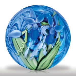 Steven Lundberg Glass Art 2002 two iris compound magnum paperweight, by Justin Lundberg. Two royal blue iris blooms, accompanied by long, thick and bladed leaves as well as pale blue spiraling ribbons of flora and a large blue bud, display against dramatically swirling blues atop a cobalt ground. Edition #2 of a limited edition of 25.